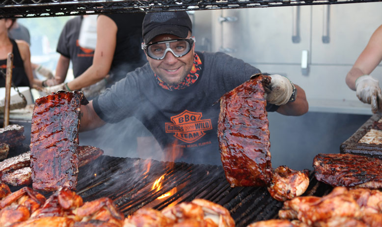 man working at large grill
